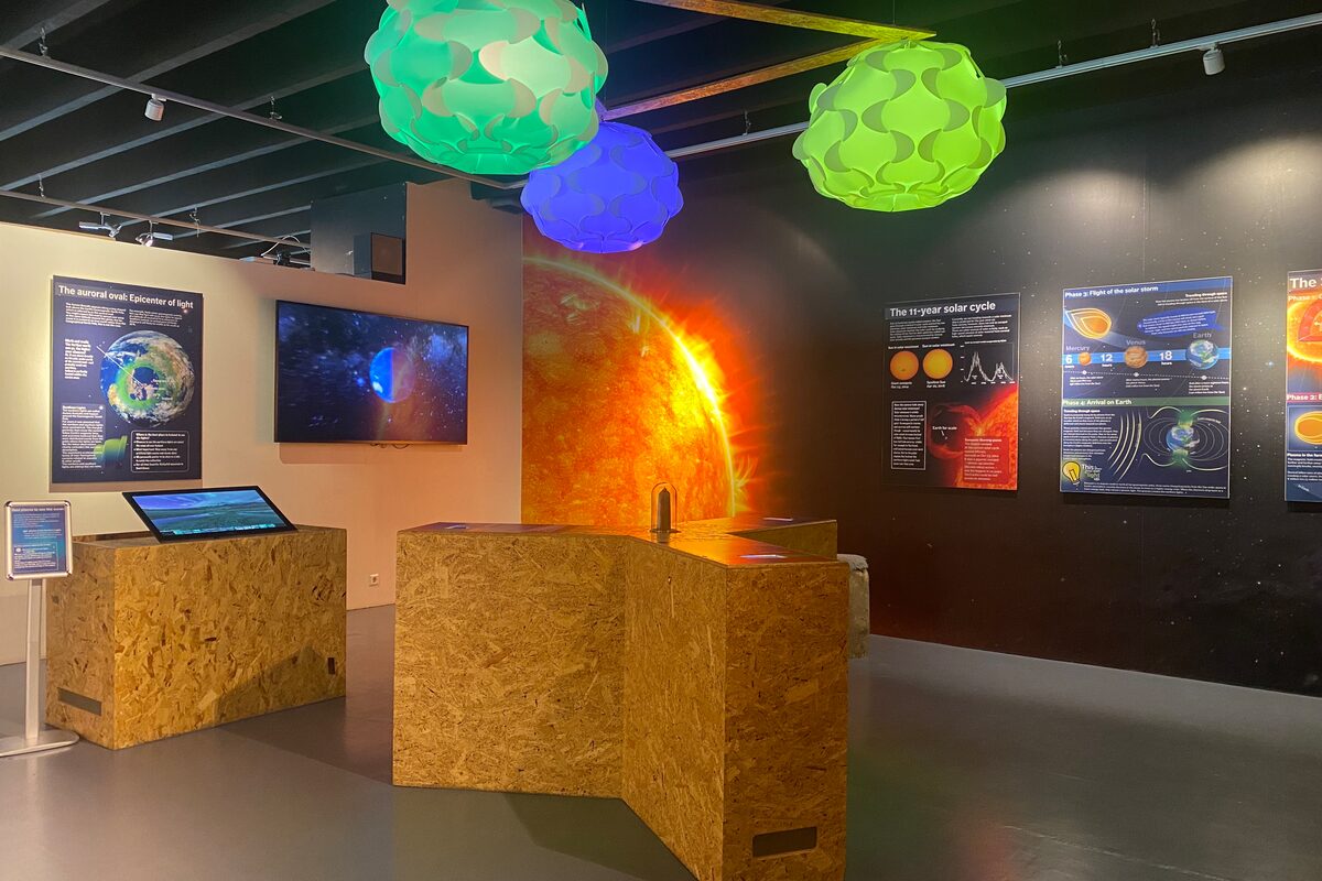 Science museum exhibit about space with posters, screens, and models