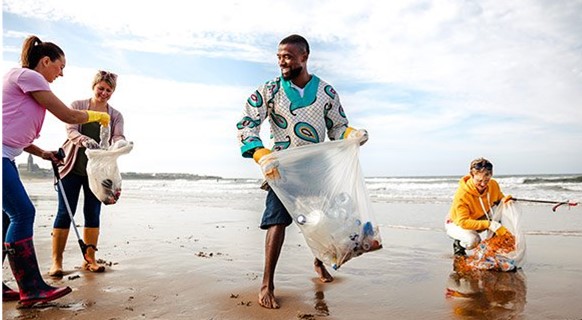 People cleaning litter from a beach together.