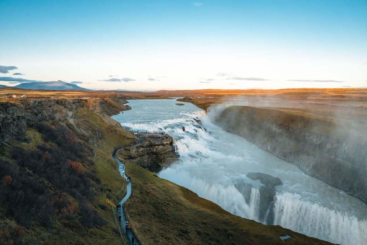 Gullfoss waterfall in Iceland with a winding path below.