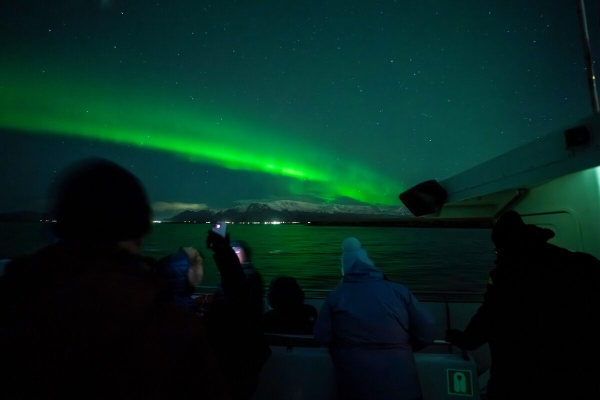 People on a boat viewing the Northern Lights.