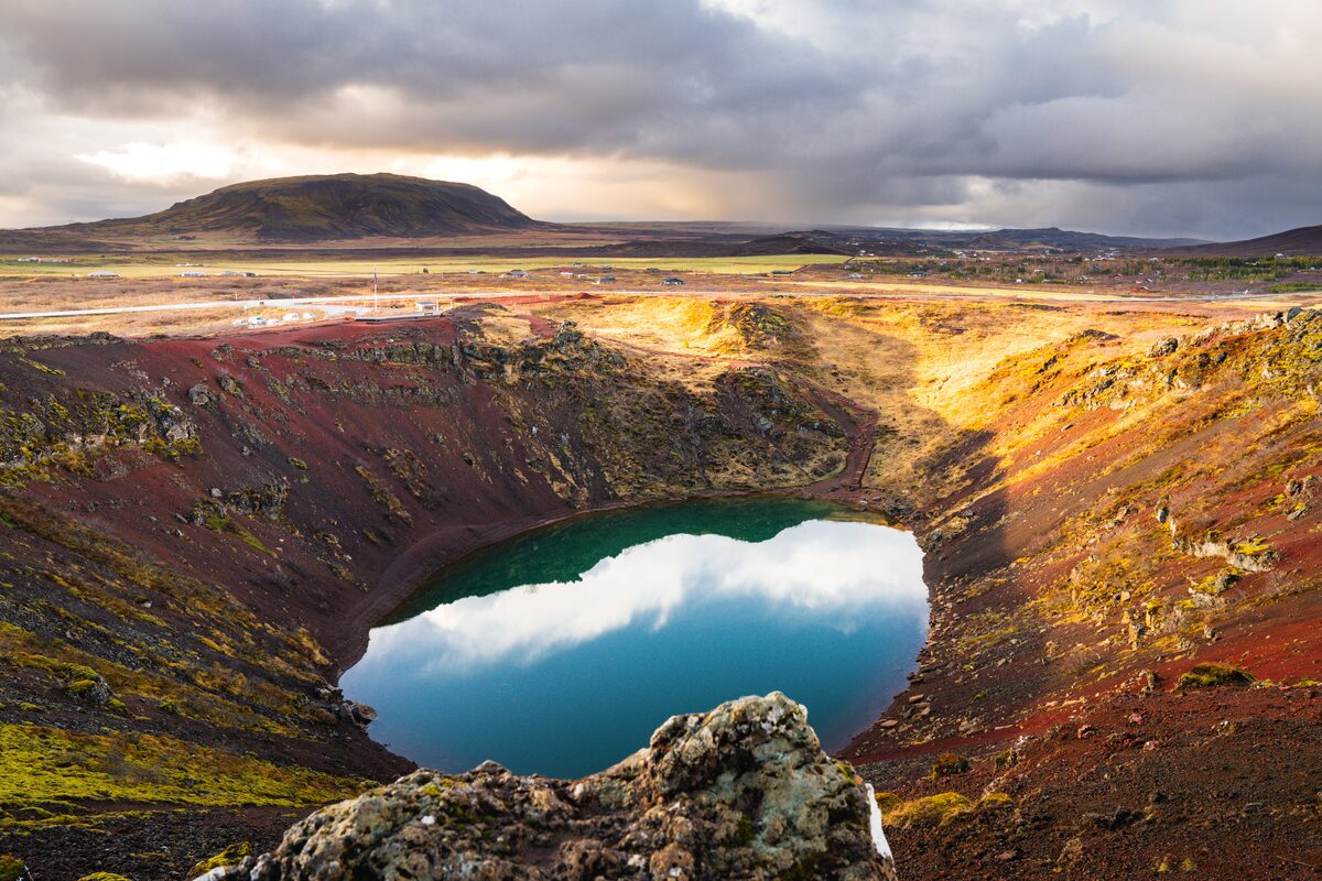 Vibrant turquoise water fills the dramatic crater of Kerið in Iceland.