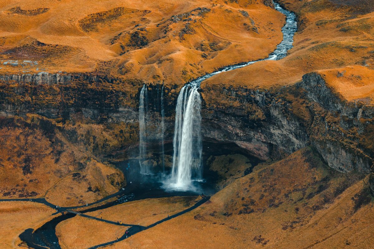 Aerial view of a waterfall with amber landscape